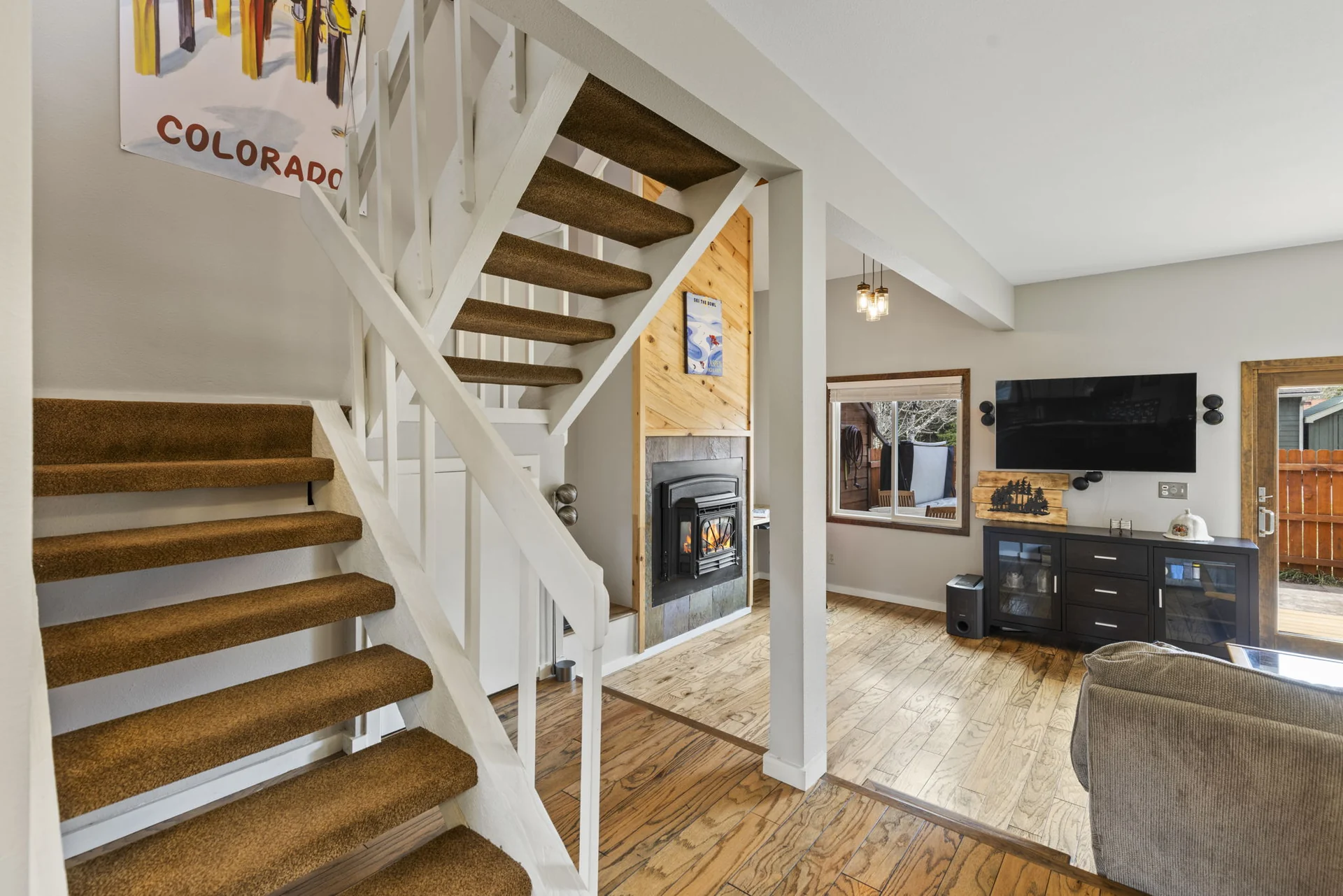 Trailside Retreat, Open staircase beside the fireplace and living room, luxury vacation rental in Silverthorne, Colorado