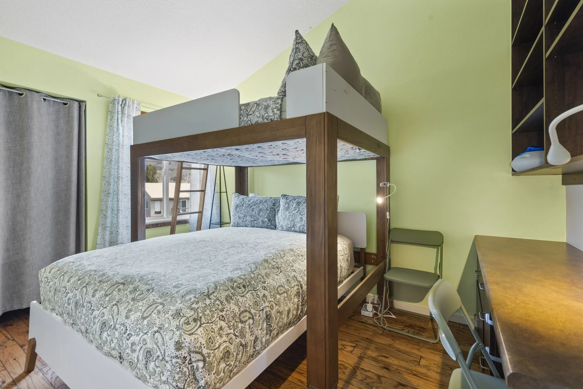 Trailside Retreat, Green bedroom with lofted bed, queen mattress below, desk, and shelving, luxury vacation rental in Silverthorne, Colorado