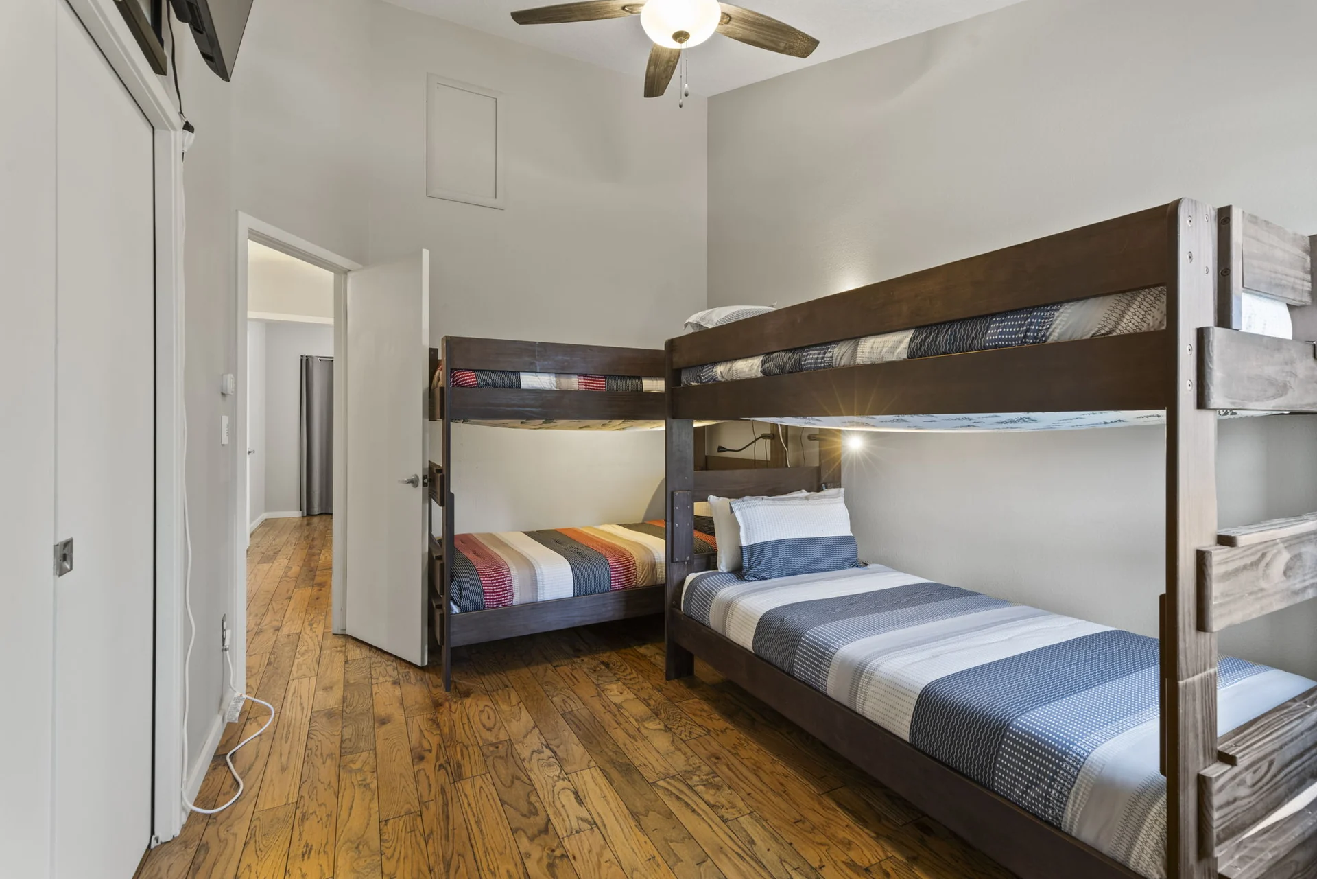 Trailside Retreat, Two wooden bunk beds with striped bedding and a ceiling fan, luxury vacation rental in Silverthorne, Colorado