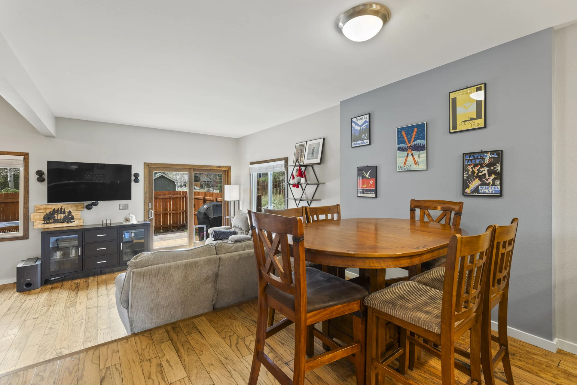 Trailside Retreat, Dining table overlooking the sofa, television, and patio doors, luxury vacation rental in Silverthorne, Colorado