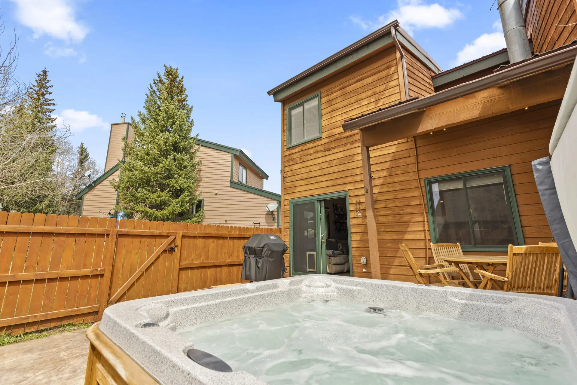 Trailside Retreat, bubbling private hot tub and fenced patio, luxury vacation rental in Silverthorne, Colorado