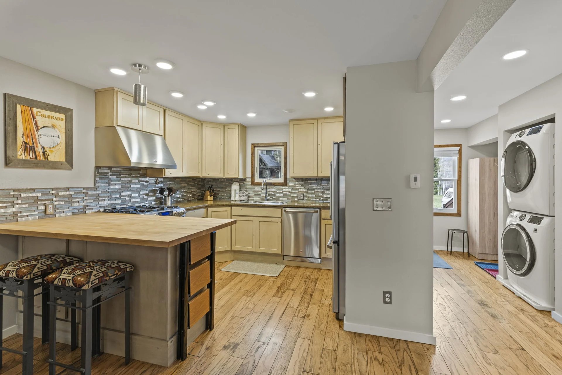 Trailside Retreat, Kitchen with island and stacked laundry visible in the adjoining hallway, luxury vacation rental in Silverthorne, Colorado