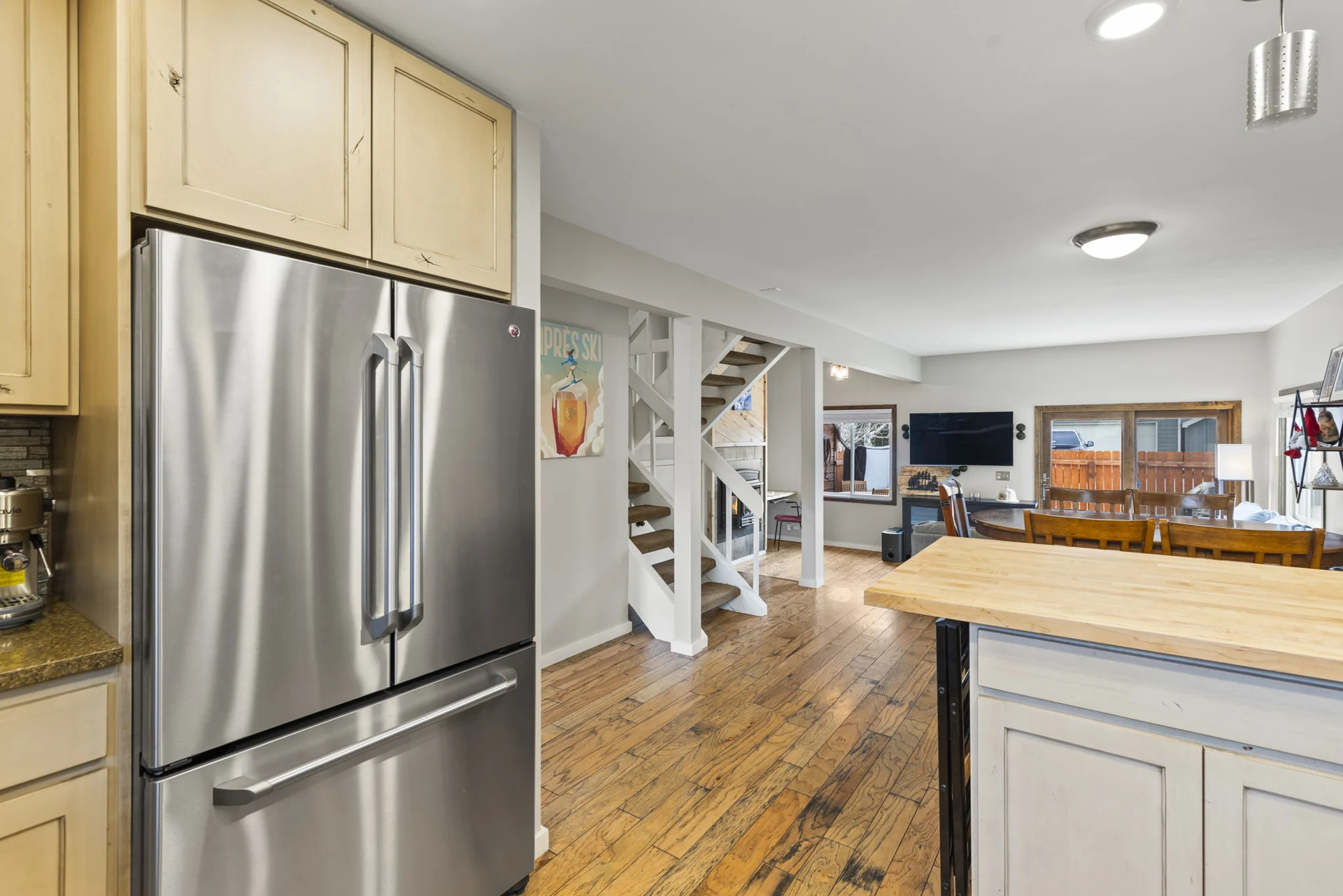 Trailside Retreat, Kitchen refrigerator and island overlooking the open living area, luxury vacation rental in Silverthorne, Colorado