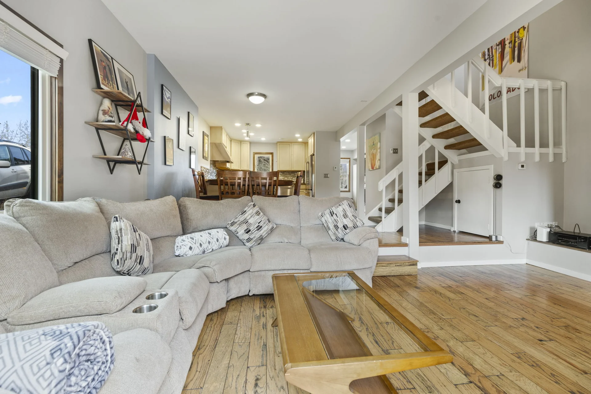 Trailside Retreat, Sectional seating opening toward the dining area and staircase, luxury vacation rental in Silverthorne, Colorado