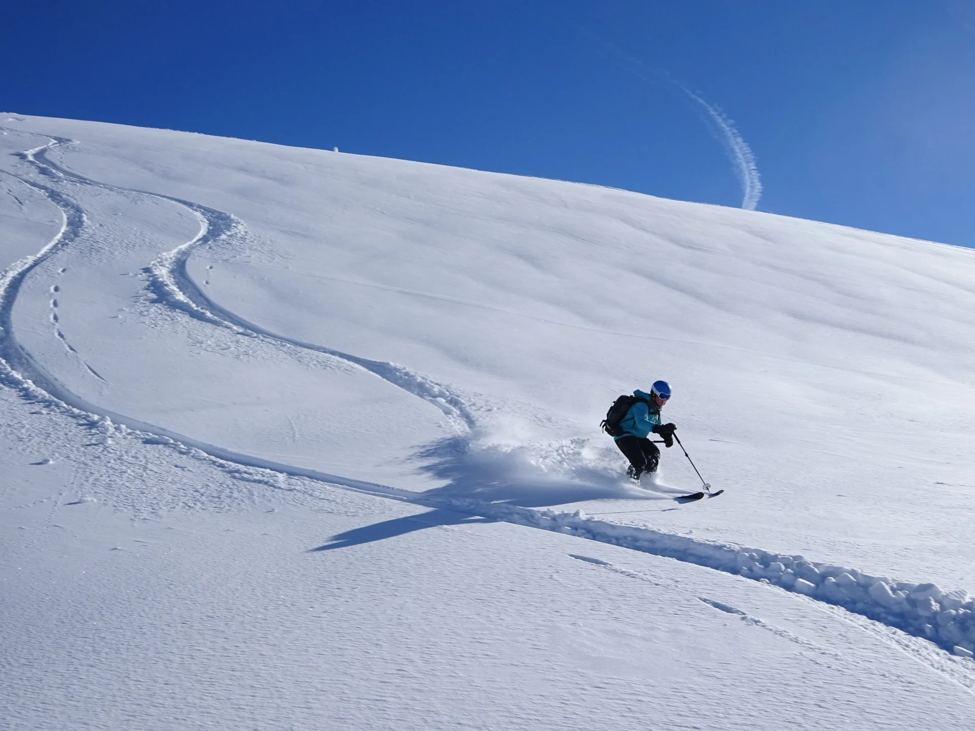 Trailside Retreat, Skier carving across an alpine slope near the retreat, luxury vacation rental in Silverthorne, Colorado